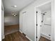 Hallway leading to the bathroom with wood-look flooring and a shower at 4965 Goldenview Ln, Lakeland, FL 33811
