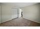 Neutral bedroom with wall closet, neutral carpeting, and view of the kitchen at 4965 Goldenview Ln, Lakeland, FL 33811