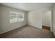 Bedroom featuring neutral carpet, a bright window and a glimpse of the entryway at 4965 Goldenview Ln, Lakeland, FL 33811