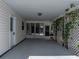 Covered carport featuring a white door, lattice covered in foliage and ample space at 4965 Goldenview Ln, Lakeland, FL 33811