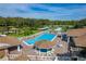 A pristine community pool is surrounded by lounge chairs and umbrellas on a sunny day at 4965 Goldenview Ln, Lakeland, FL 33811