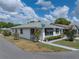 Charming single-story home featuring manicured landscaping and a signpost showing the street names at 4965 Goldenview Ln, Lakeland, FL 33811