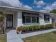 Close up of the home's exterior showing the door, window awning and planter at 4965 Goldenview Ln, Lakeland, FL 33811