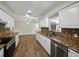 Bright kitchen featuring granite countertops, stainless steel appliances, and wood-look flooring at 4965 Goldenview Ln, Lakeland, FL 33811