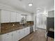 Updated kitchen featuring granite countertops, stainless steel appliances, and wood-look flooring at 4965 Goldenview Ln, Lakeland, FL 33811