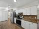Well-appointed kitchen featuring modern stainless steel appliances and granite countertops at 4965 Goldenview Ln, Lakeland, FL 33811
