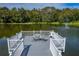 A beautiful pier on a pond with a table and chairs providing a scenic and relaxing atmosphere at 4965 Goldenview Ln, Lakeland, FL 33811