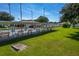 Community shuffleboard courts with covered seating, green lawns, and an American flag creating a recreational space at 4965 Goldenview Ln, Lakeland, FL 33811