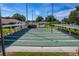 Outdoor shuffleboard courts featuring multiple lanes, covered seating, and well-maintained landscaping under a clear blue sky at 4965 Goldenview Ln, Lakeland, FL 33811