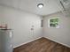 Utility room with water heater, storage shelves, and a small window at 4965 Goldenview Ln, Lakeland, FL 33811