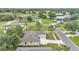 Aerial view showcasing the property's roof, large lot, mature trees, and neighborhood at 505 Shanklin Ave, Bartow, FL 33830