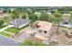 Aerial view of new construction home in a neighborhood near a tranquil pond, surrounded by trees at 505 Shanklin Ave, Bartow, FL 33830