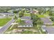 An aerial view showcases a residential neighborhood with well-maintained lawns and mature trees and a view of a nearby lake at 505 Shanklin Ave, Bartow, FL 33830