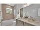 Bathroom featuring dual sinks, bath and shower, and framed mirrors with modern lighting at 505 Shanklin Ave, Bartow, FL 33830
