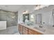 Modern bathroom with a double vanity, large mirror, and a glass-enclosed shower at 505 Shanklin Ave, Bartow, FL 33830