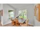Sunlit dining area features a rustic wood table and views of the landscaped yard at 505 Shanklin Ave, Bartow, FL 33830