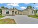 Charming single-story home with stone accents, a well-manicured lawn, and a spacious driveway leading to a two-car garage at 505 Shanklin Ave, Bartow, FL 33830