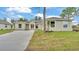 Single-story home boasting stone accents, a manicured lawn, and a spacious driveway, exhibiting appealing curb appeal at 505 Shanklin Ave, Bartow, FL 33830
