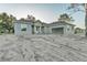 Single-Gathering home featuring a freshly painted exterior, an attached garage, and a raw landscape at 505 Shanklin Ave, Bartow, FL 33830