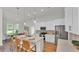Modern kitchen featuring quartz countertops, stainless steel appliances, an island with bar seating, and adjacent dining area at 505 Shanklin Ave, Bartow, FL 33830