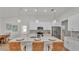 Modern kitchen featuring white cabinets, quartz countertops, stainless steel appliances, and pendant lighting above a center island at 505 Shanklin Ave, Bartow, FL 33830