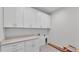 Laundry room boasting white cabinets, modern countertops, and ample storage at 505 Shanklin Ave, Bartow, FL 33830