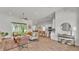 Spacious living area with wood floors and neutral decor flows into a modern kitchen with a backyard view at 505 Shanklin Ave, Bartow, FL 33830