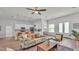 Open-concept living space with wood floors and neutral decor flows into a modern kitchen with bar stool seating at 505 Shanklin Ave, Bartow, FL 33830