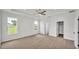 Large main bedroom with neutral carpet, large windows, and a ceiling fan at 505 Shanklin Ave, Bartow, FL 33830