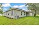 Exterior side view showcasing the home's stucco siding and well-maintained landscaping at 505 Shanklin Ave, Bartow, FL 33830