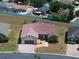 Beautiful aerial view of a single-Gathering home featuring manicured landscaping and a stone facade at 5612 Vintage View Blvd, Lakeland, FL 33812