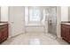 Bright bathroom featuring a soaking tub, glass-enclosed shower, double vanity, and tile floor at 5612 Vintage View Blvd, Lakeland, FL 33812
