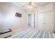 This bedroom features tiled flooring, a ceiling fan, and closet space for storage at 5612 Vintage View Blvd, Lakeland, FL 33812