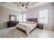Cozy bedroom with ceiling fan, neutral walls, tiled floor, and a view of the neighborhood through the windows at 5612 Vintage View Blvd, Lakeland, FL 33812