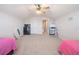 Bonus room with two beds, a ceiling fan, and large doors at 5612 Vintage View Blvd, Lakeland, FL 33812
