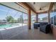 Comfortable outdoor seating area, table, ceiling fan, and view of the pool from a covered patio at 5612 Vintage View Blvd, Lakeland, FL 33812