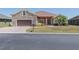 Beautiful home featuring stone accents, manicured landscaping, and a two-car garage at 5612 Vintage View Blvd, Lakeland, FL 33812