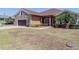 Single-story home with stone and siding exterior, two-car garage, and landscaped front yard at 5612 Vintage View Blvd, Lakeland, FL 33812