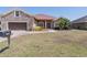 Charming single-Gathering home with stone accents, a manicured lawn, and a two-car garage at 5612 Vintage View Blvd, Lakeland, FL 33812