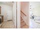 Hallway connecting a laundry room to a bedroom with stairs in between at 5612 Vintage View Blvd, Lakeland, FL 33812