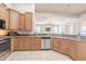 Spacious kitchen with stainless steel appliances, wooden cabinets, and open access to the living area at 5612 Vintage View Blvd, Lakeland, FL 33812