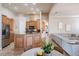 Open-concept kitchen with a large island, stainless steel refrigerator, and natural wood cabinets and a view to the living room at 5612 Vintage View Blvd, Lakeland, FL 33812