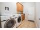 Well-equipped laundry room with front loading washer and dryer and lots of cabinet space for easy organization at 5612 Vintage View Blvd, Lakeland, FL 33812