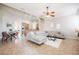 Bright living room featuring a sectional sofa, ceiling fan, and tile flooring, open to the dining room and kitchen at 5612 Vintage View Blvd, Lakeland, FL 33812