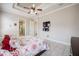 Comfortable main bedroom featuring a decorative ceiling, tiled floor, and ensuite bath at 5612 Vintage View Blvd, Lakeland, FL 33812