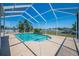A sparkling screened in pool with blue water and a stone feature is perfect for outdoor relaxation at 5612 Vintage View Blvd, Lakeland, FL 33812