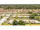 Wide aerial showing the community layout, landscape and proximity to the river; highlighted home has an arrow at 610 Cottage Ln, Lakeland, FL 33803