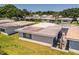Community aerial view showing rooftops, landscaping, patios, and the overall layout of the neighborhood at 610 Cottage Ln, Lakeland, FL 33803