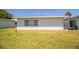 Exterior shot of the home showcasing the well-maintained lawn and the overall backyard space for outdoor activities at 610 Cottage Ln, Lakeland, FL 33803