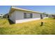 Angle of the home's exterior showing a view of the backyard and the property's clean and tidy outdoor space at 610 Cottage Ln, Lakeland, FL 33803